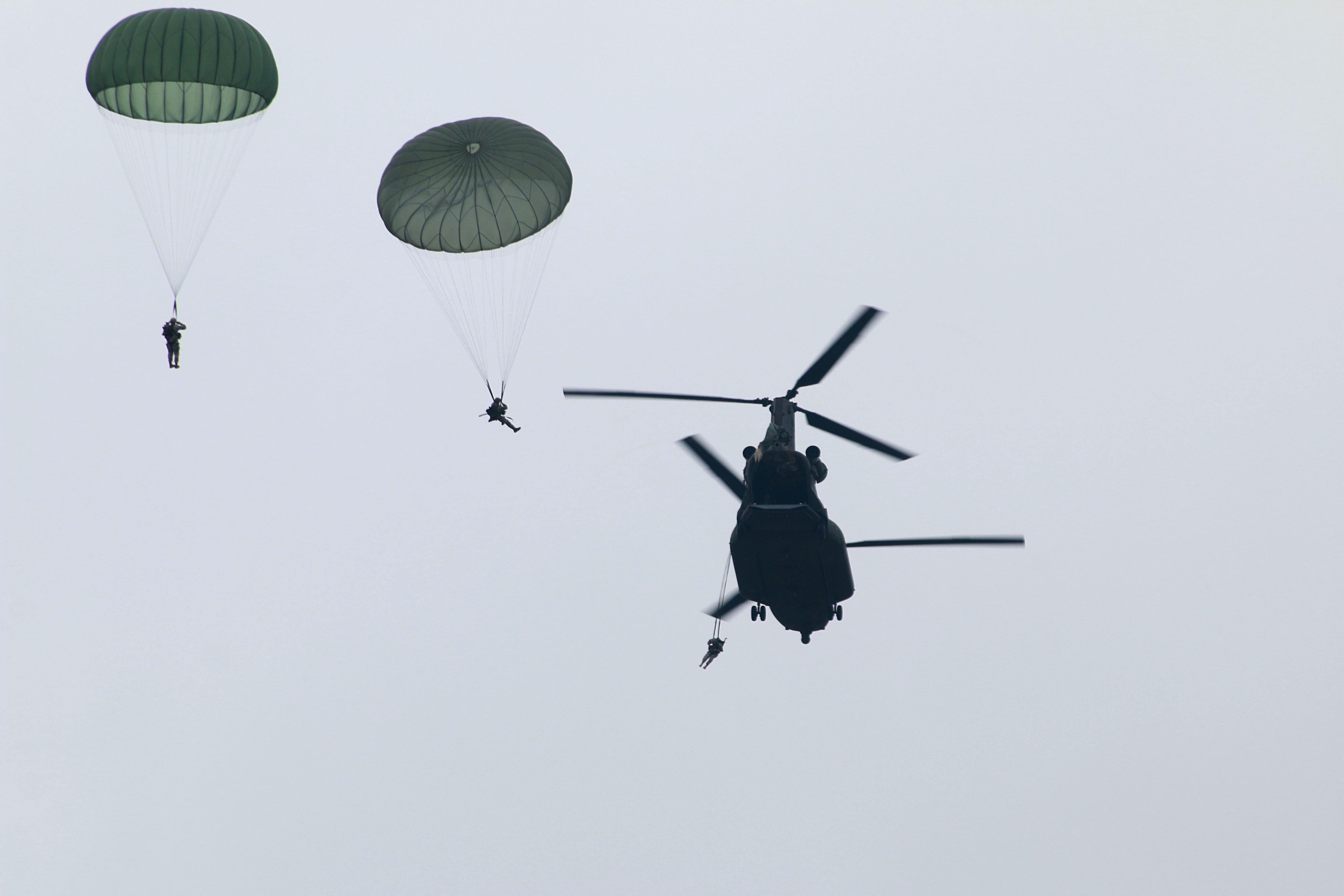 U.S. paratroopers utilizing T-11 parachutes conduct an airborne