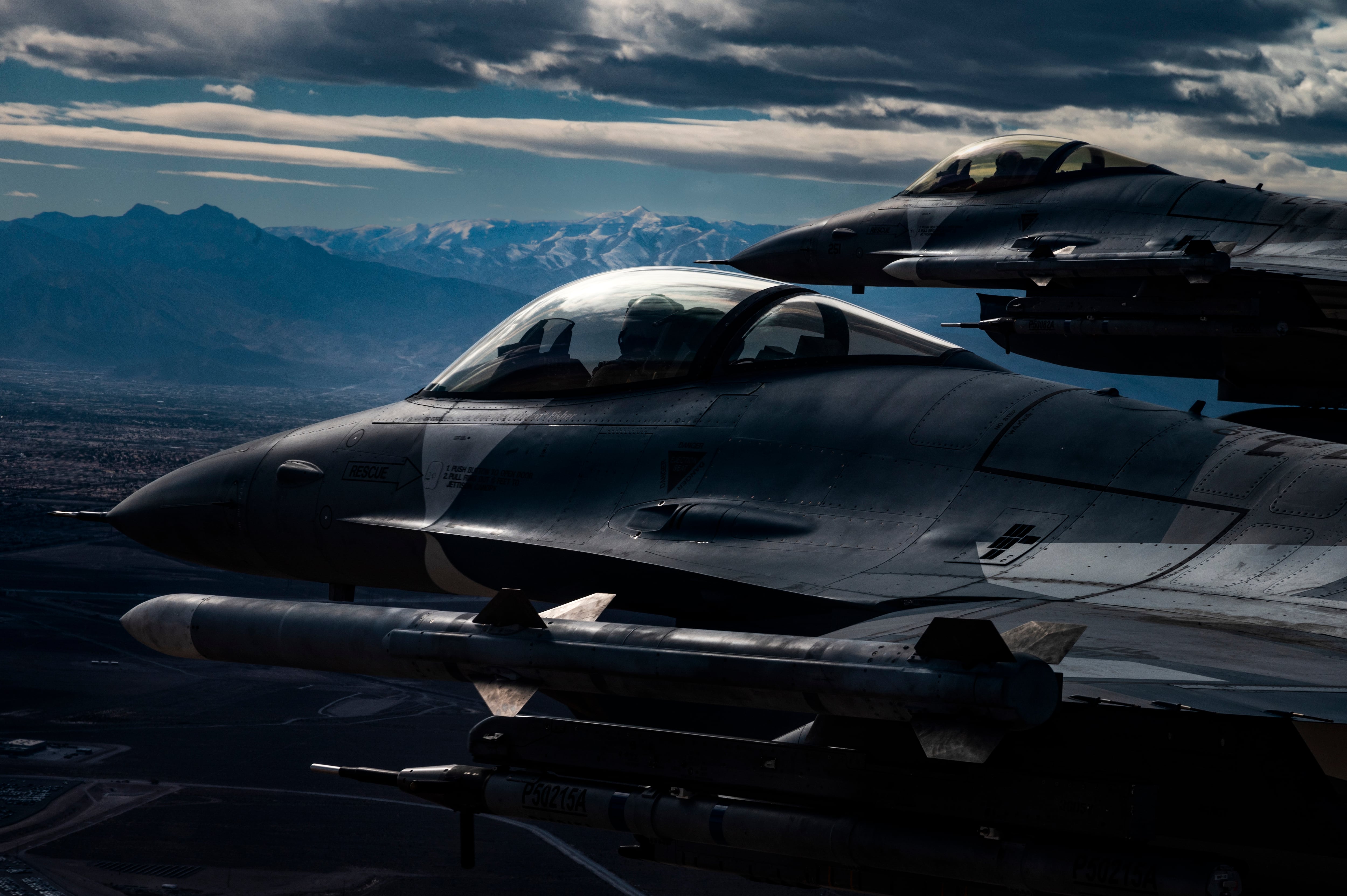 Two F-16 Fighting Falcons assigned to the 64th Aggressor Squadron fly past downtown Las Vegas, Nev., following exercise aerial combat operations during Red Flag-Nellis 22-2 at Nellis Air Force Base, Nev., March 9, 2022. Red Flag-Nellis 22-2 is an exercise demonstrating tactical integration of airpower from the U.S. and its primary allies. (Tech. Sgt. Alexandre Montes/Air Force)