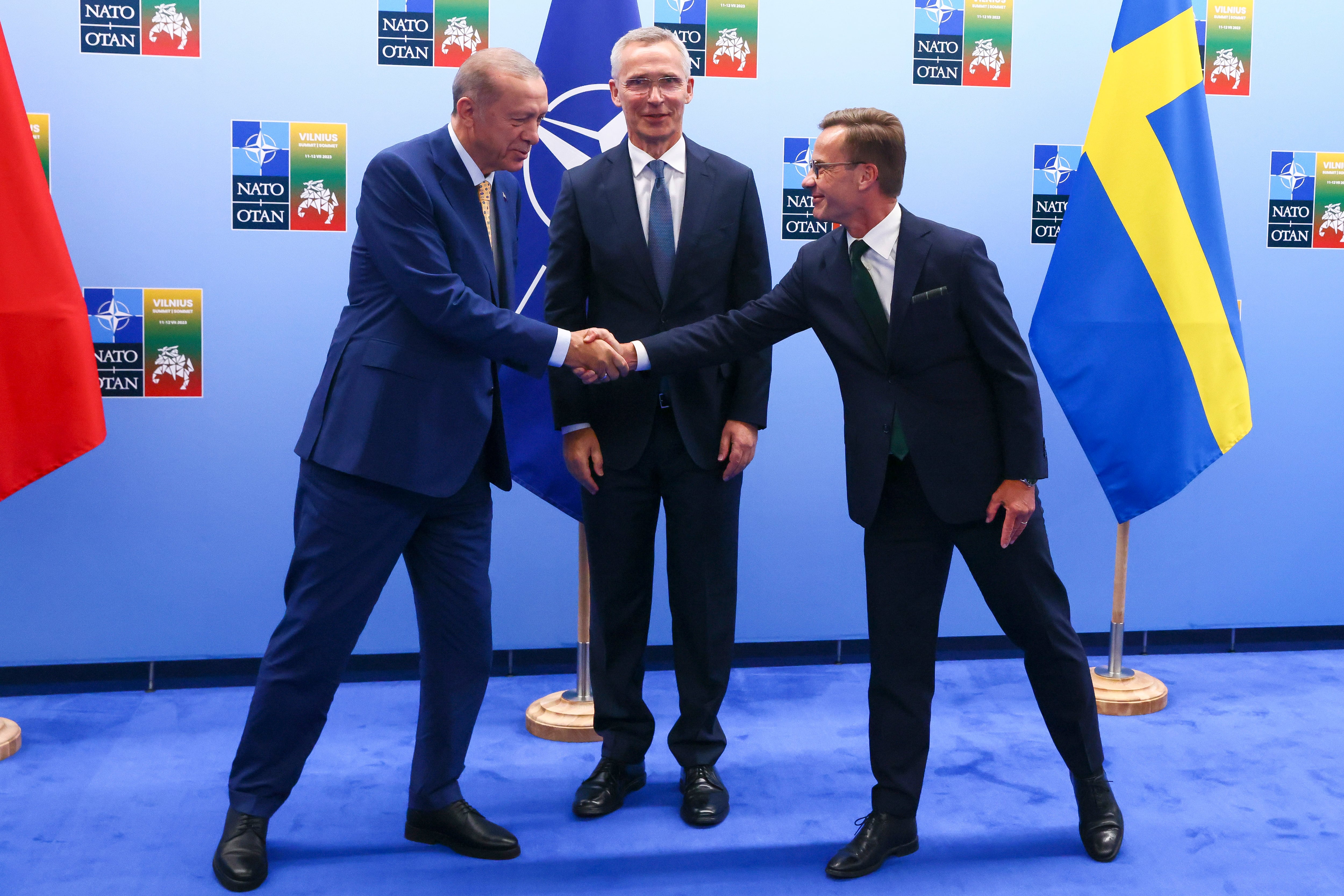 Turkey's President Recep Tayyip Erdogan, left, shakes hands with Sweden's Prime Minister Ulf Kristersson, right, as NATO Secretary General Jens Stoltenberg looks on prior to a meeting ahead of a NATO summit in Vilnius, Lithuania, Monday, July 10, 2023.