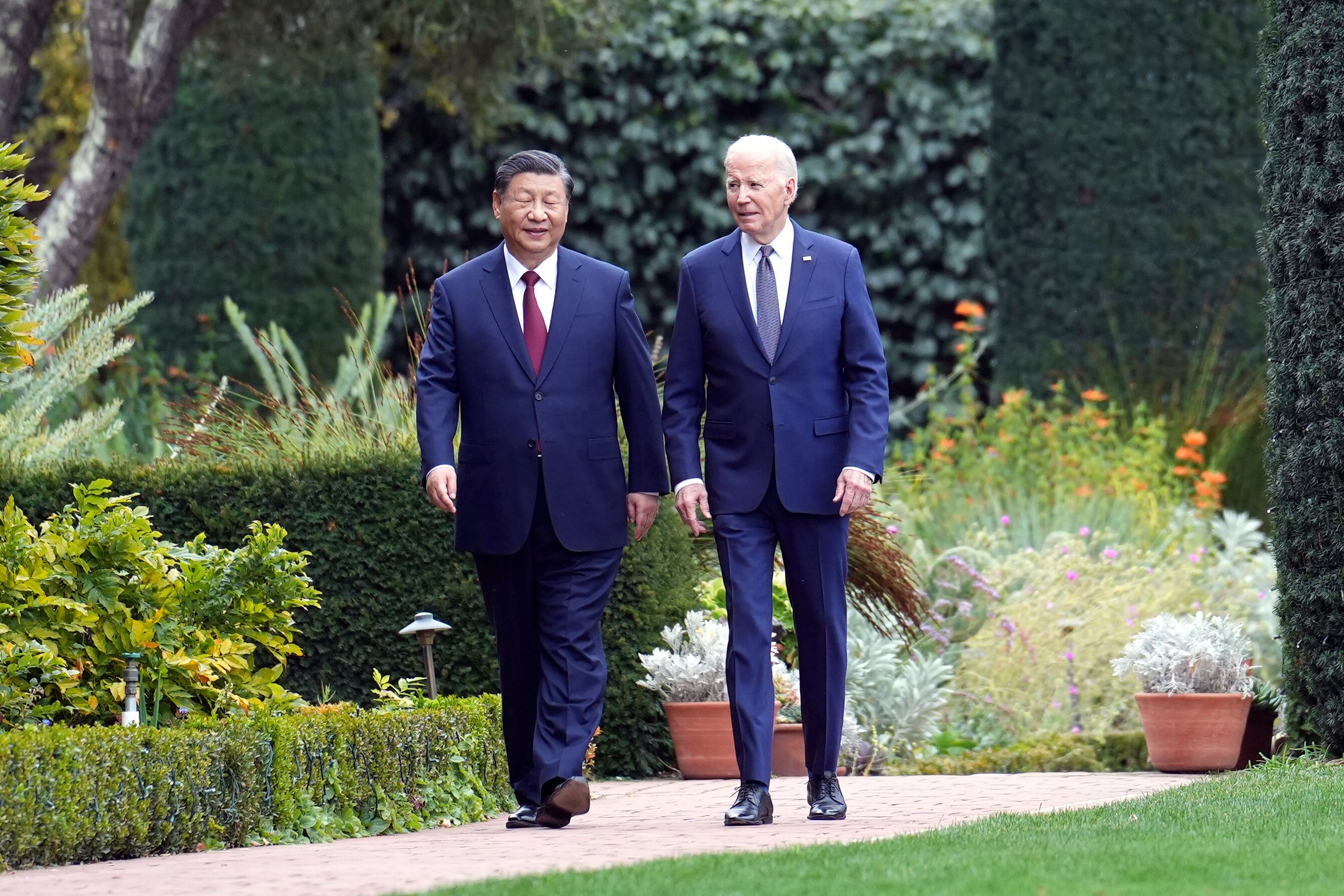 President Joe Biden and China's President President Xi Jinping walk in the gardens at the Filoli Estate in Woodside, Calif., Wednesday, Nov, 15, 2023, on the sidelines of the Asia-Pacific Economic Cooperative conference.