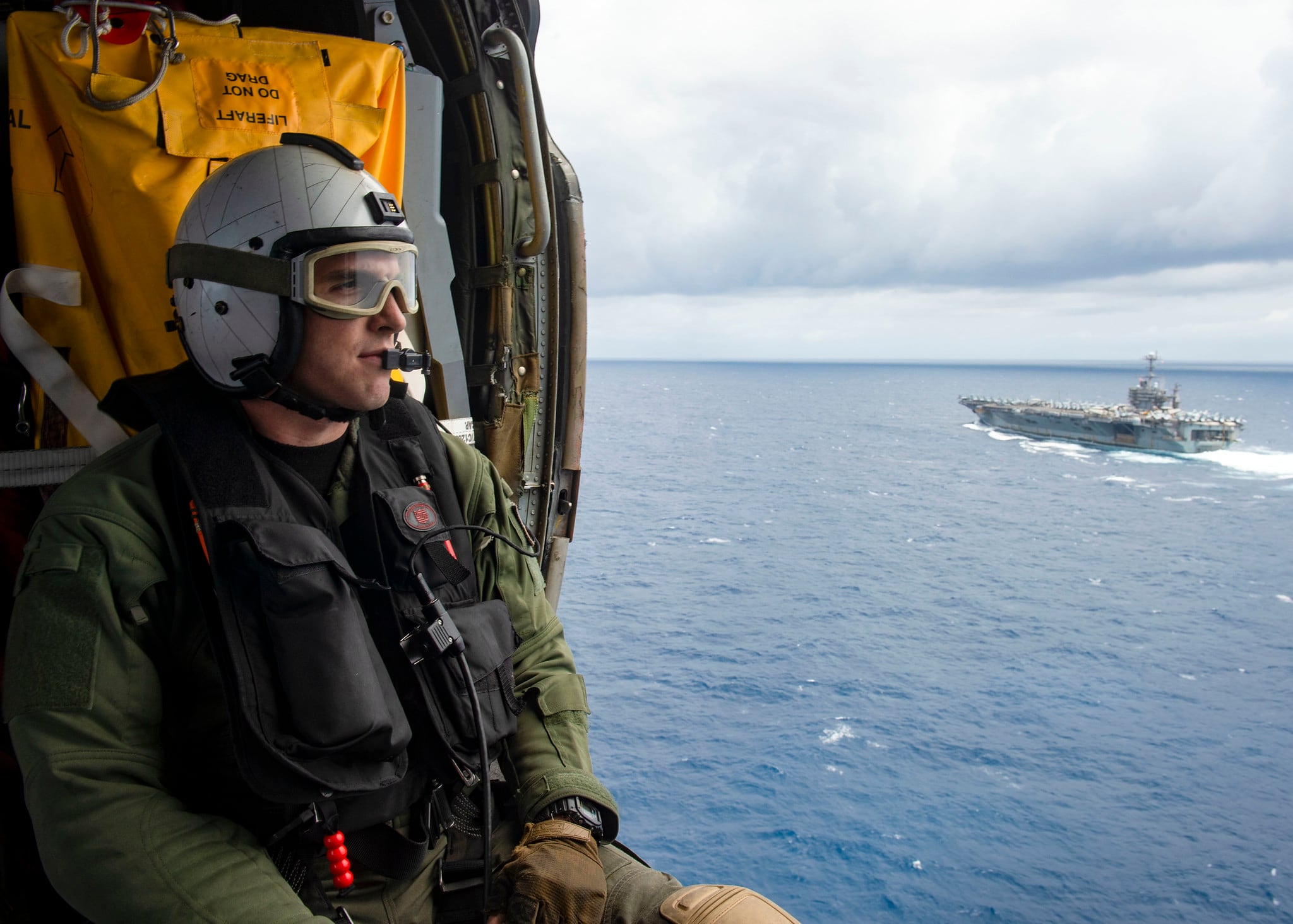 Naval Air Crewman (Helicopter) 3rd Class Jake Shelton observes the Nimitz-class aircraft carrier USS Harry S. Truman (CVN 75) in the Atlantic Ocean on May 27, 2020.