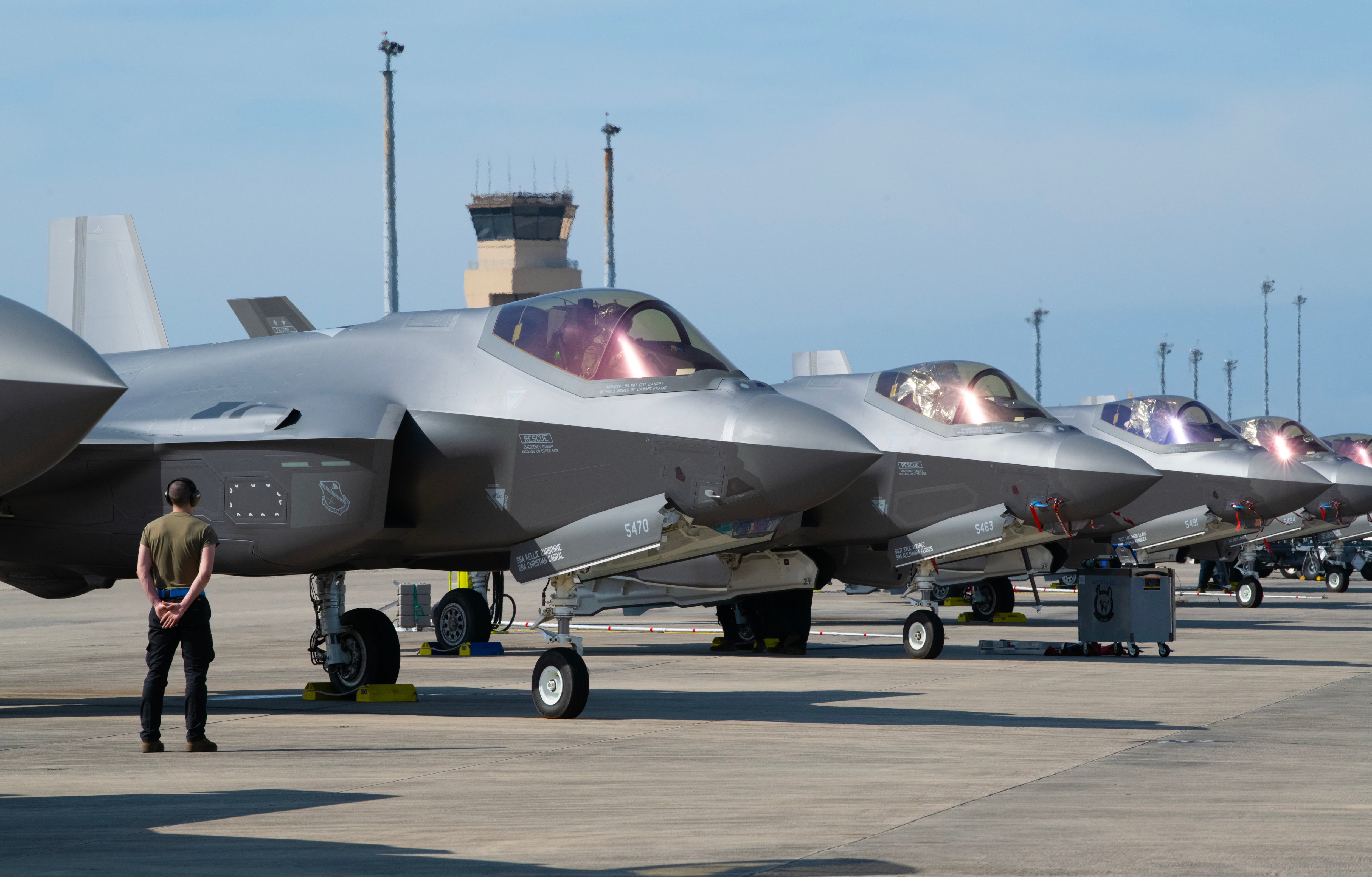 An airman waits for an F-35A Lightning II engine start-up during the Weapons System Evaluation Program-East 23.05 at Tyndall Air Force Base, Florida, Feb. 15, 2023.