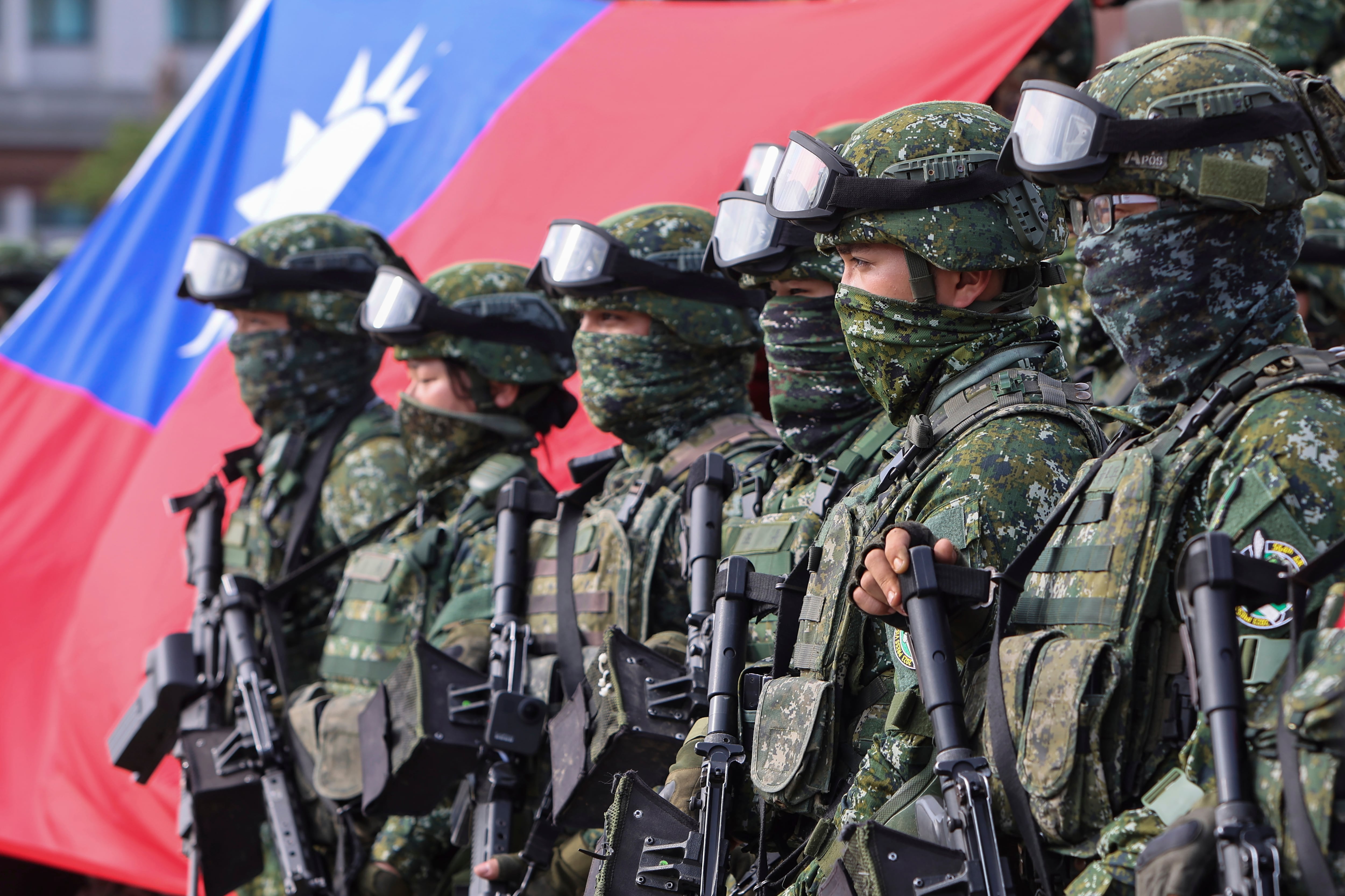 Soldiers pose for group photos with a Taiwan flag after a preparedness enhancement drill simulating the defense against Beijing's military intrusions, ahead of the Lunar New Year in Kaohsiung City, Taiwan on Jan. 11, 2023.