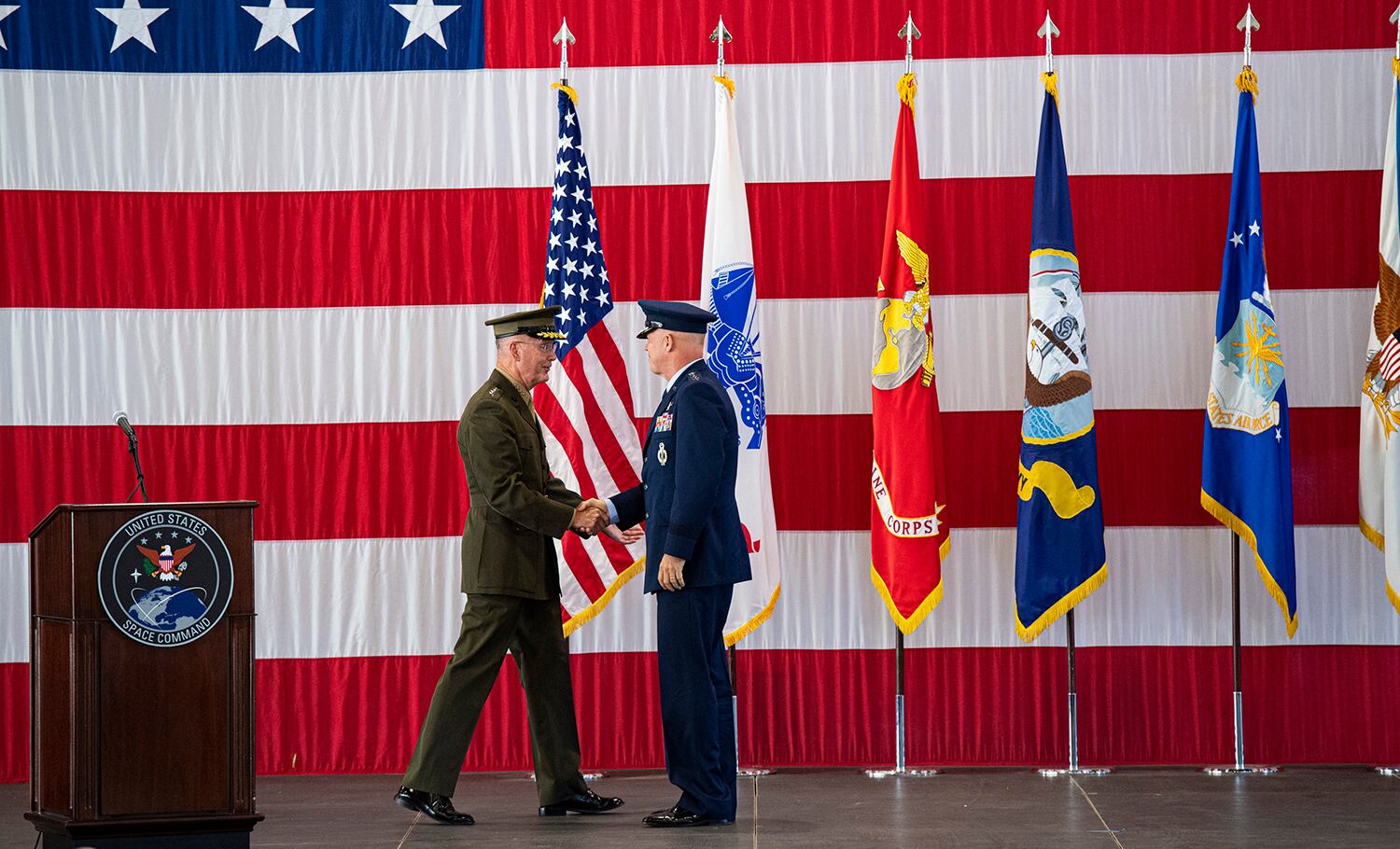 Joint Chiefs of Staff Gen. Joseph F. Dunford Jr., left, shakes hands with Gen. John W. Raymond, the commander of the U.S. Space Command