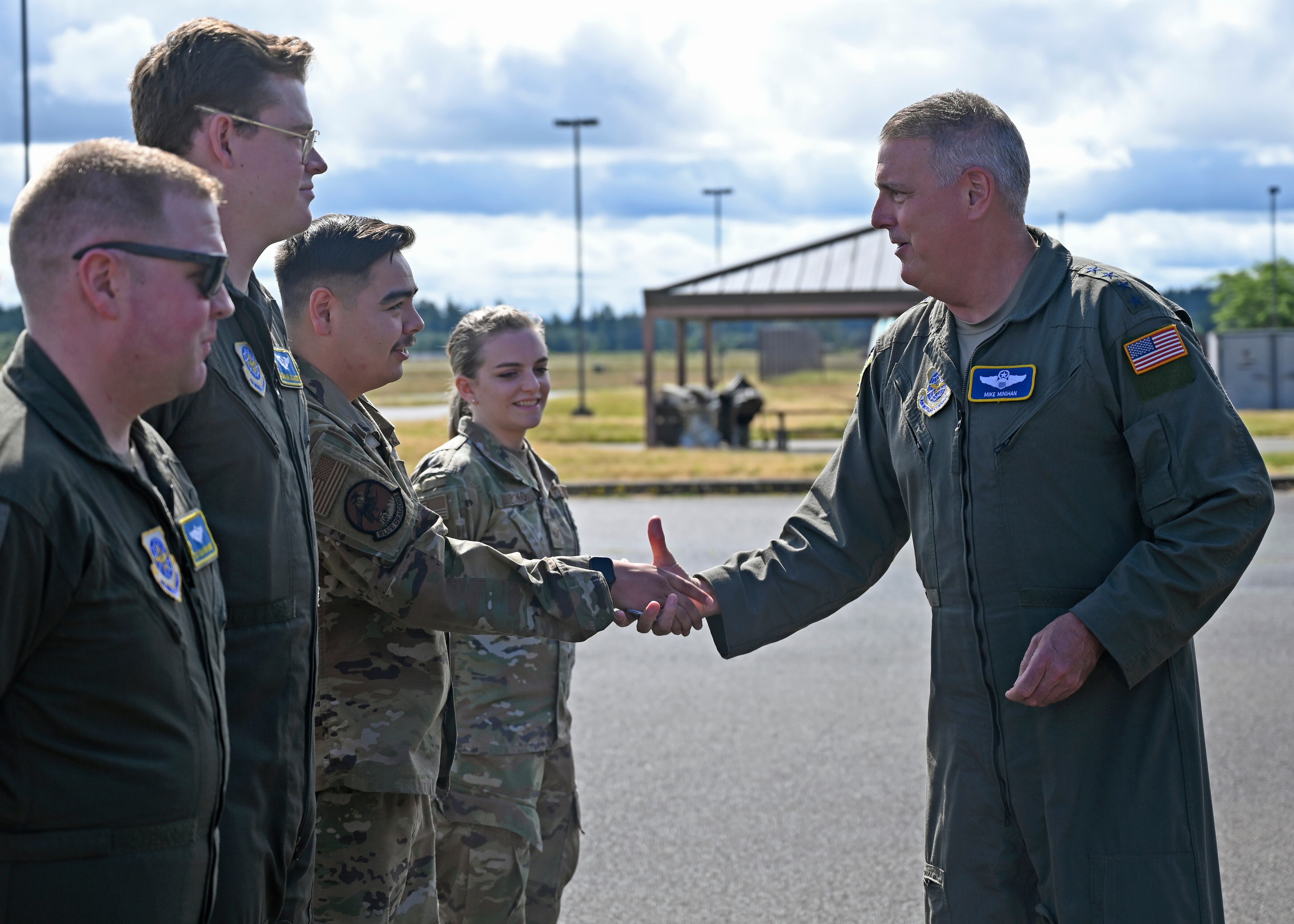 Air Force Gen. Mike Minihan, Air Mobility Command commander, coins the 2021 AMC Doolittle Award winners during his visit to Joint Base Lewis-McChord, Washington, July 7, 2022. The crew of RCH683 was recognized for their participation in Operation Allies Refuge, which evacuated thousands of Afghans from Kabul, Afghanistan, in August 2021. (Senior Airman Callie Norton/Air Force)