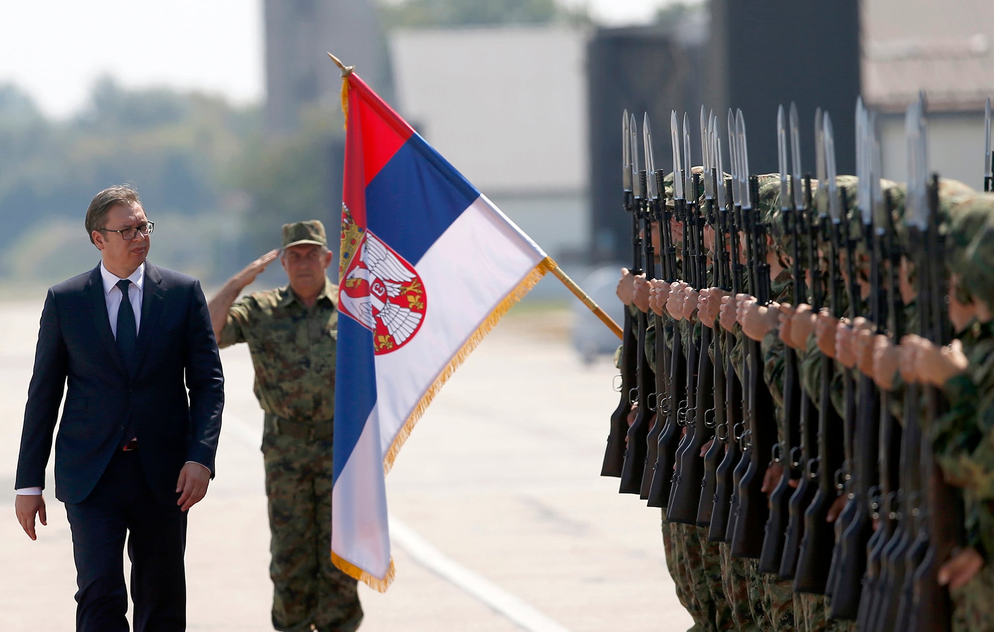 In this Aug. 21, 2018, file photo, Serbian President Aleksandar Vucic, left, reviews an honor guard on the tarmac at Batajnica, military airport near Belgrade, Serbia.