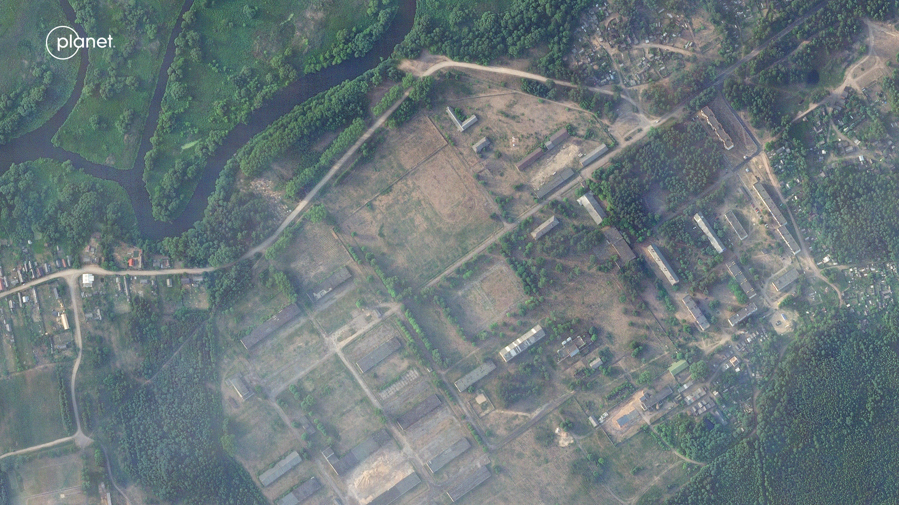 This satellite image provided by Planet Labs PBC taken on Thursday, June 15, 2023, shows a former military base outside the Belarusian town of Osipovichi shows no signs of the structures that appeared two weeks later.