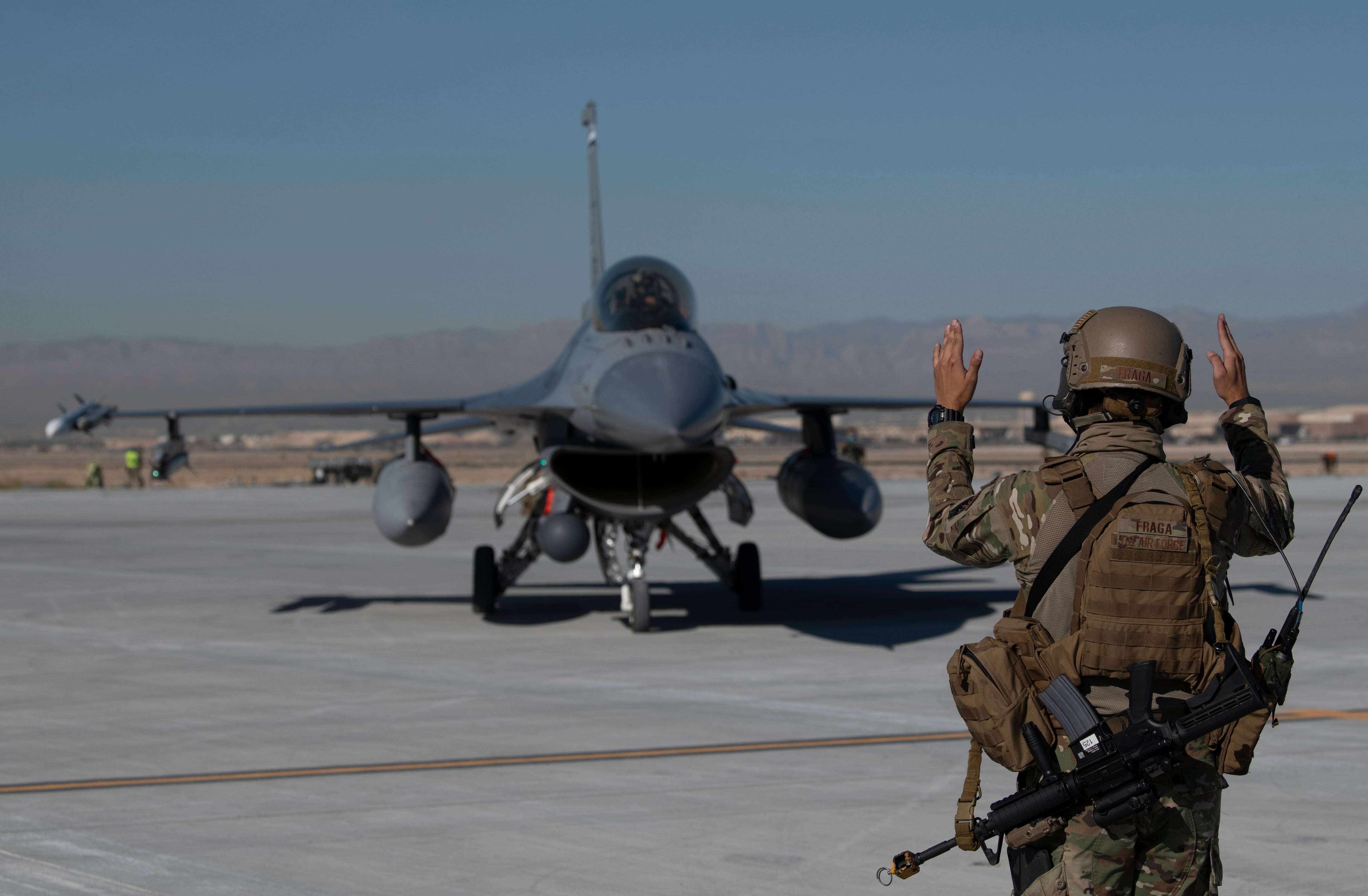 Tech. Sgt. Nestor Fraga guides an F-16 Fighting Falcon during an Advanced Battle Management System exercise at Nellis Air Force Base, Nevada, in 2020.