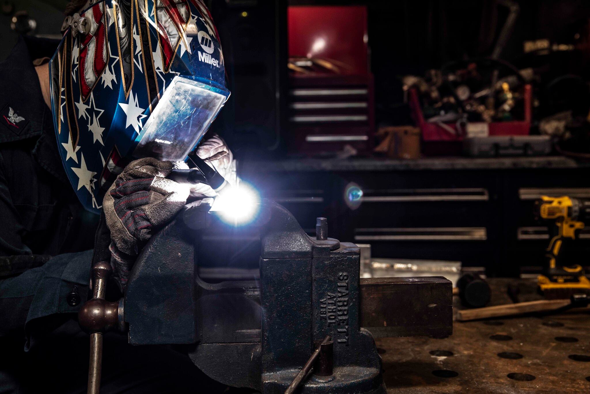 Hull Maintenance Technician 3rd Class Drew Knutson welds stainless steel and aluminum angles in the repair shop of the aircraft carrier USS Ronald Reagan (CVN 76) on July 8, 2020, in the South China Sea.