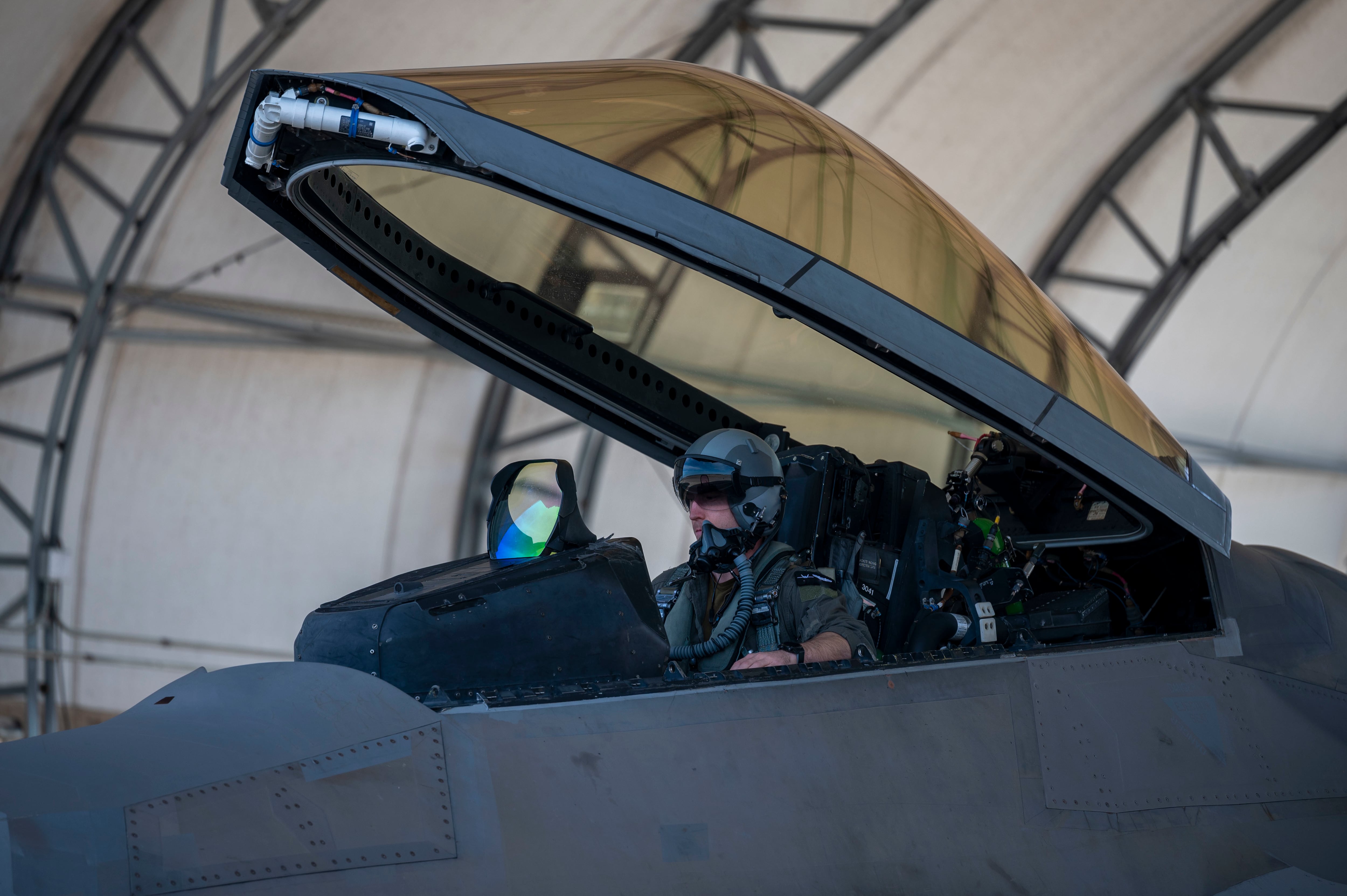 A U.S. Air Force instructor pilot assigned to the 43rd Fighter Squadron, conducts F-22 Raptor start-up procedures at Eglin Air Force Base, Florida, Feb. 1, 2022. Since the Raptor is a single-seat aircraft, instructor pilots fly alongside students during aerial missions after the student has become proficient in a simulator. The Air Force altered the photo for security purposes by blurring out identification patches. (Airman 1st Class Tiffany Price/Air Force)