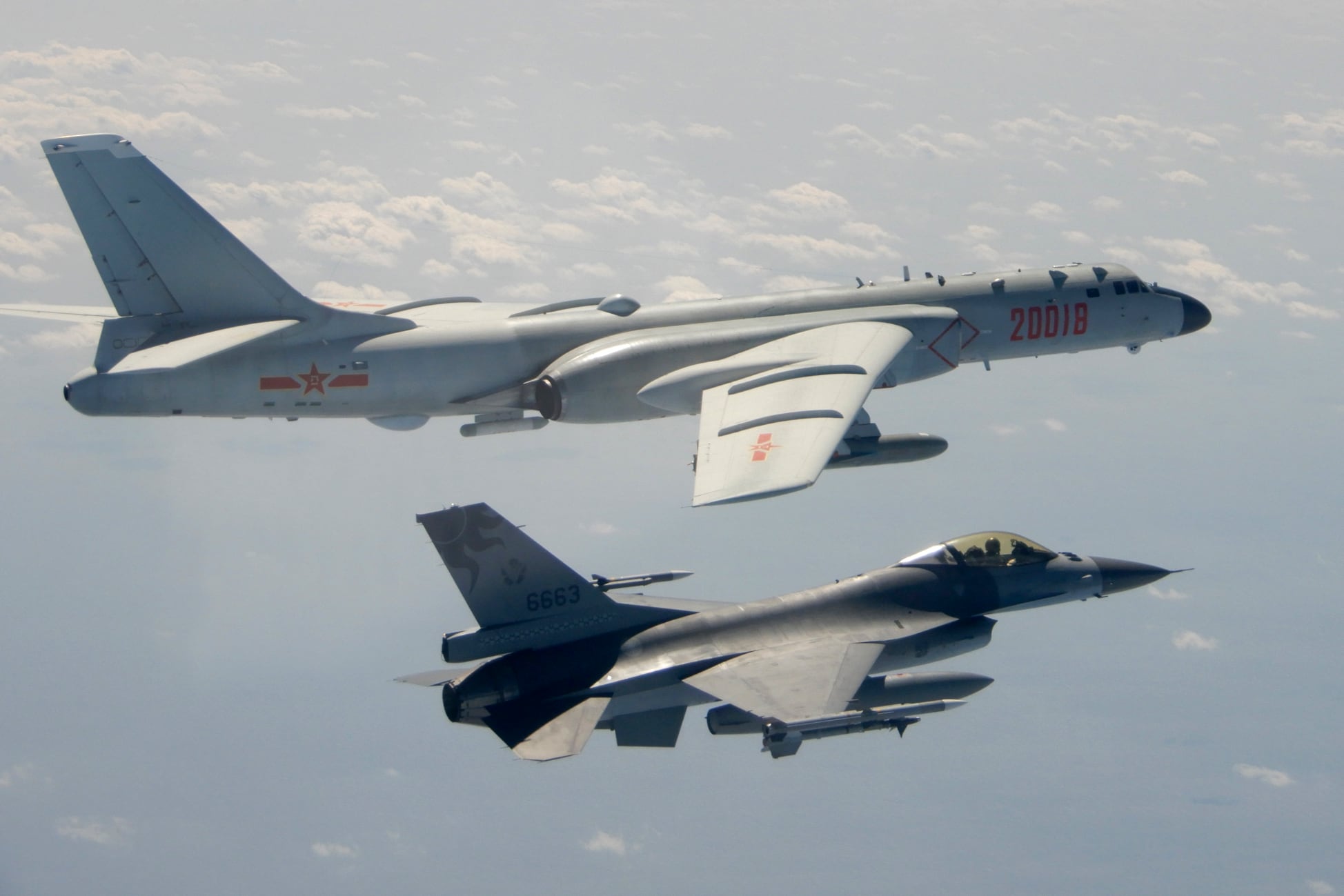 In this photo taken Feb. 10, 2020, and released by the Republic of China (ROC) Ministry of National Defense, a Taiwanese Air Force F-16 in foreground flies on the flank of a Chinese People's Liberation Army Air Force (PLAAF) H-6 bomber as it passes near Taiwan.