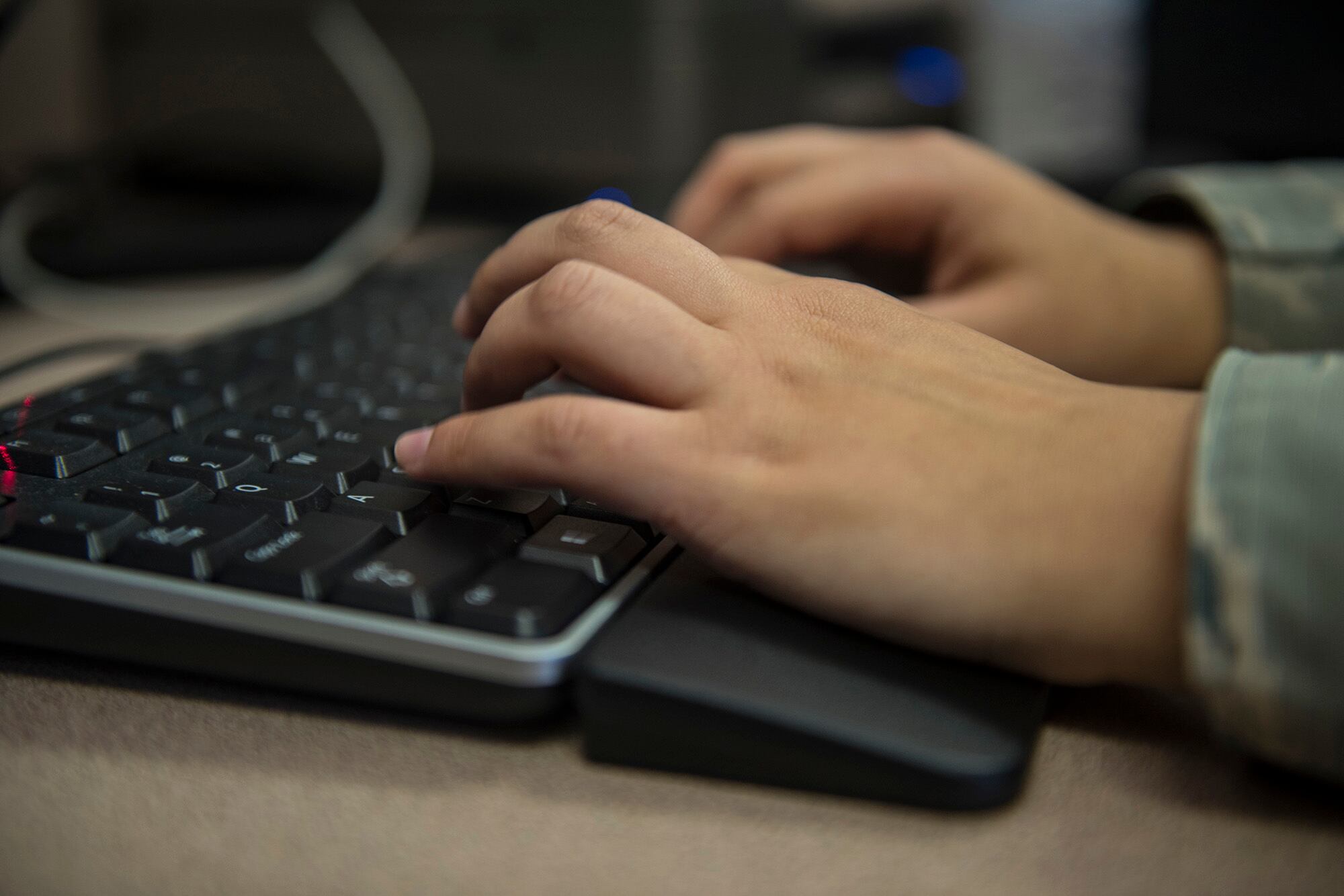 U.S. Air Force Airman 1st Class Leann Munoz, 18th Force Support Squadron customer service technician, types on a computer March 29, 2018, at Kadena Air Base, Japan.